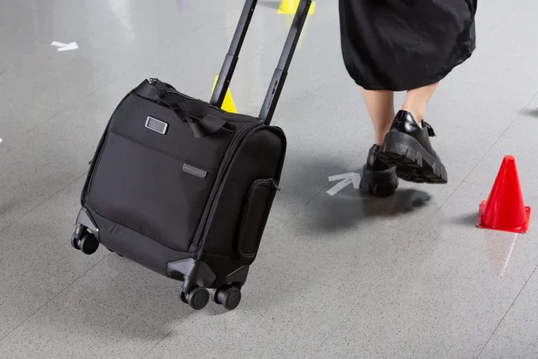 open carry-on interior showing padded laptop compartment and packing compartments