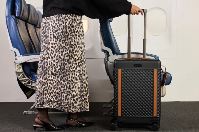 close-up of a front-opening carry-on suitcase unzipped to show laptop compartment