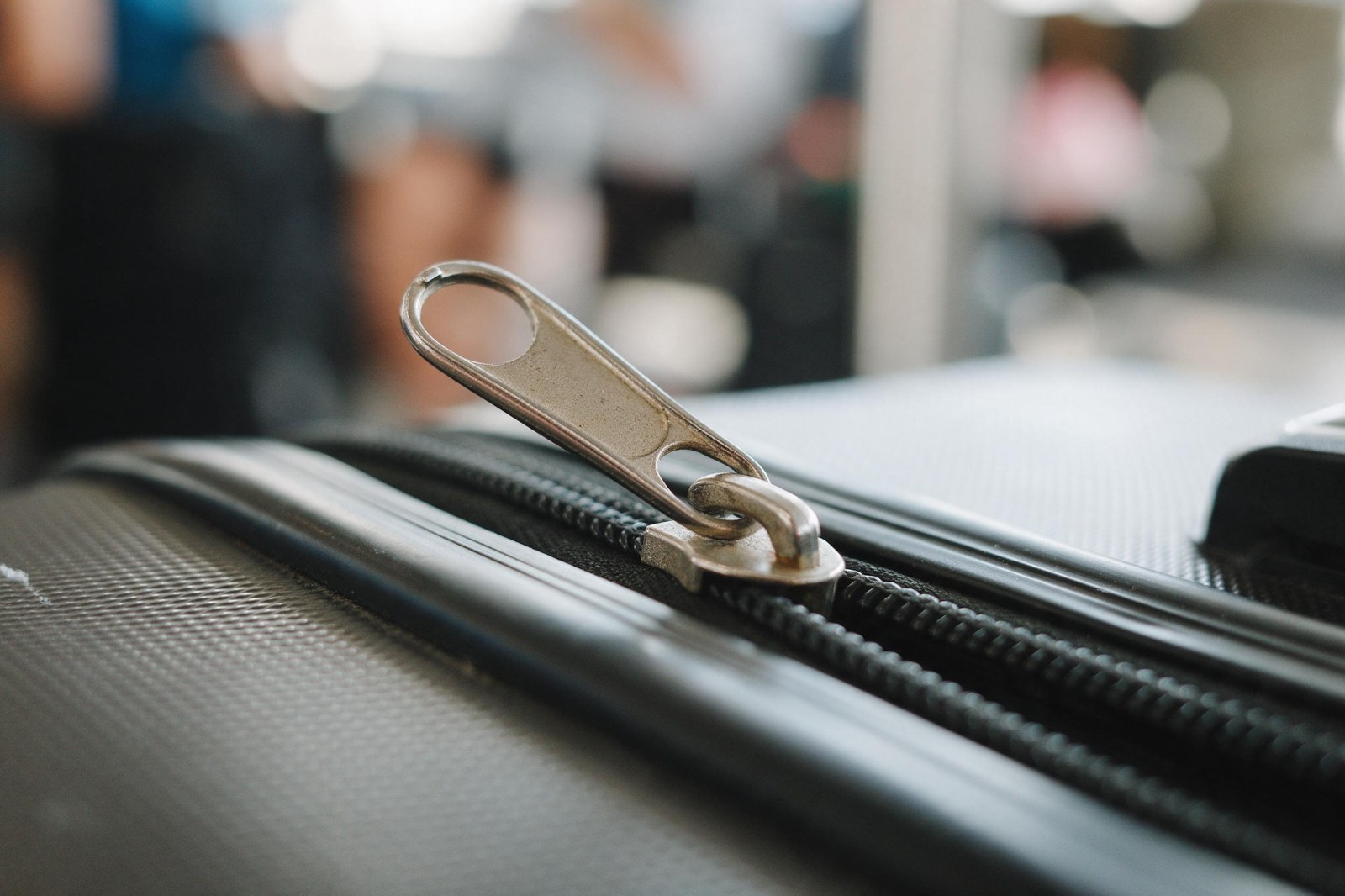 close-up of bent zipper pull on suitcase